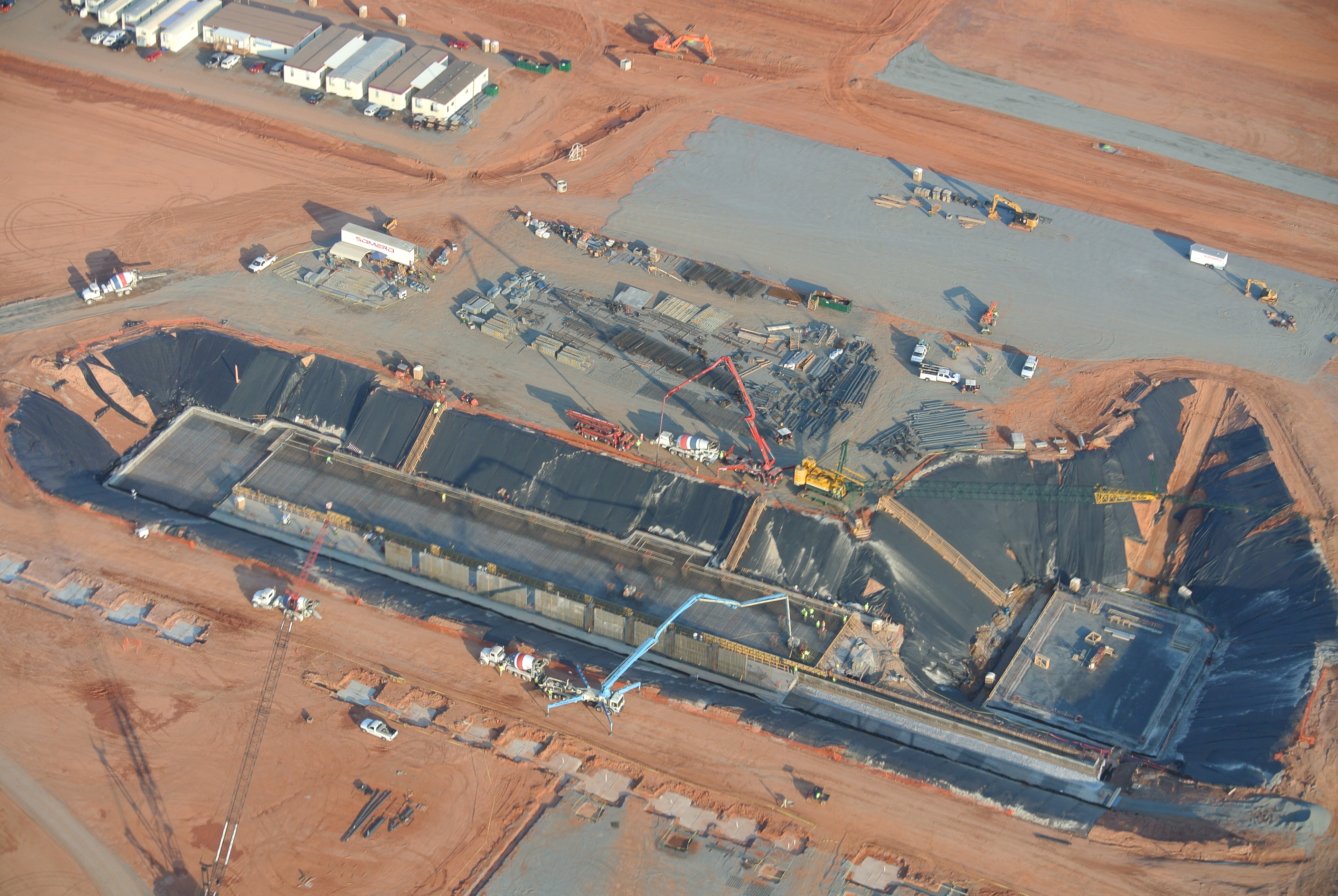Aerial view of a large concrete pour with crews, pumps, and equipment